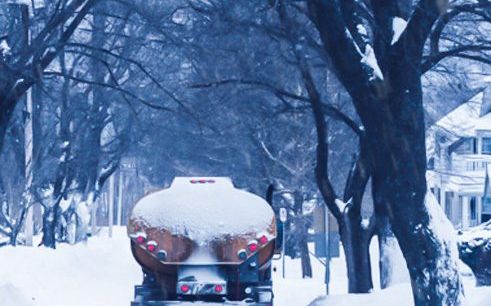 Heating oil tanker making deliveries on a snow-covered Long Island street