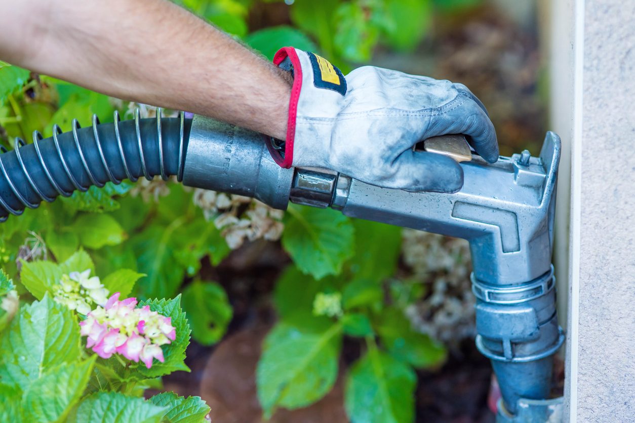 Discount fuel oil delivery nozzle locked into a residential fill pipe